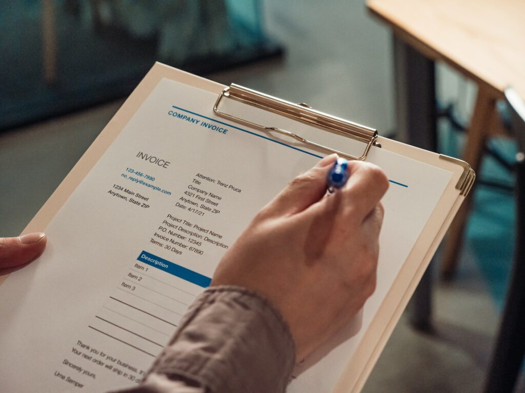 close-up-shot-of-a-person-holding-a-clipboard