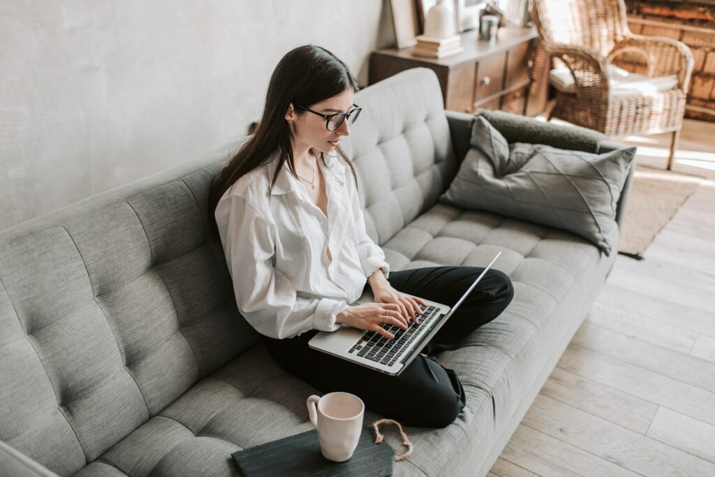 A female accountant sitting on the couch reading a forum