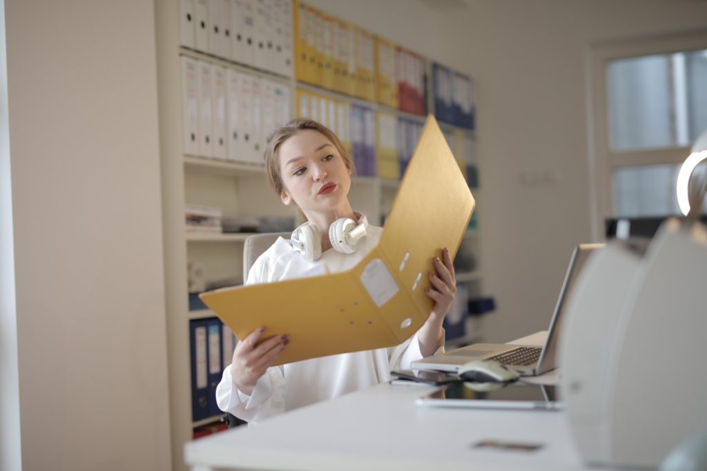 A female accountant holding a yellow file