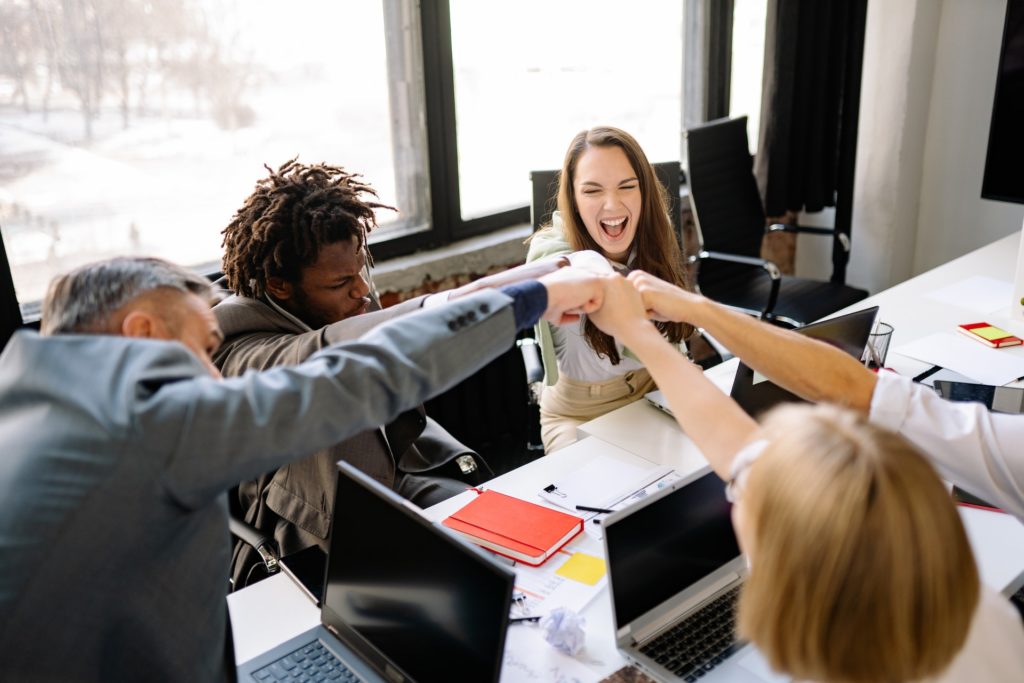 An accounting team fist pumping