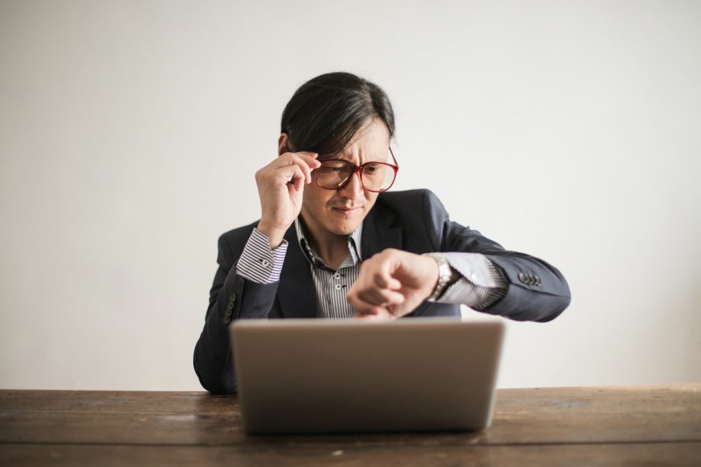 A male accountant checking his watch