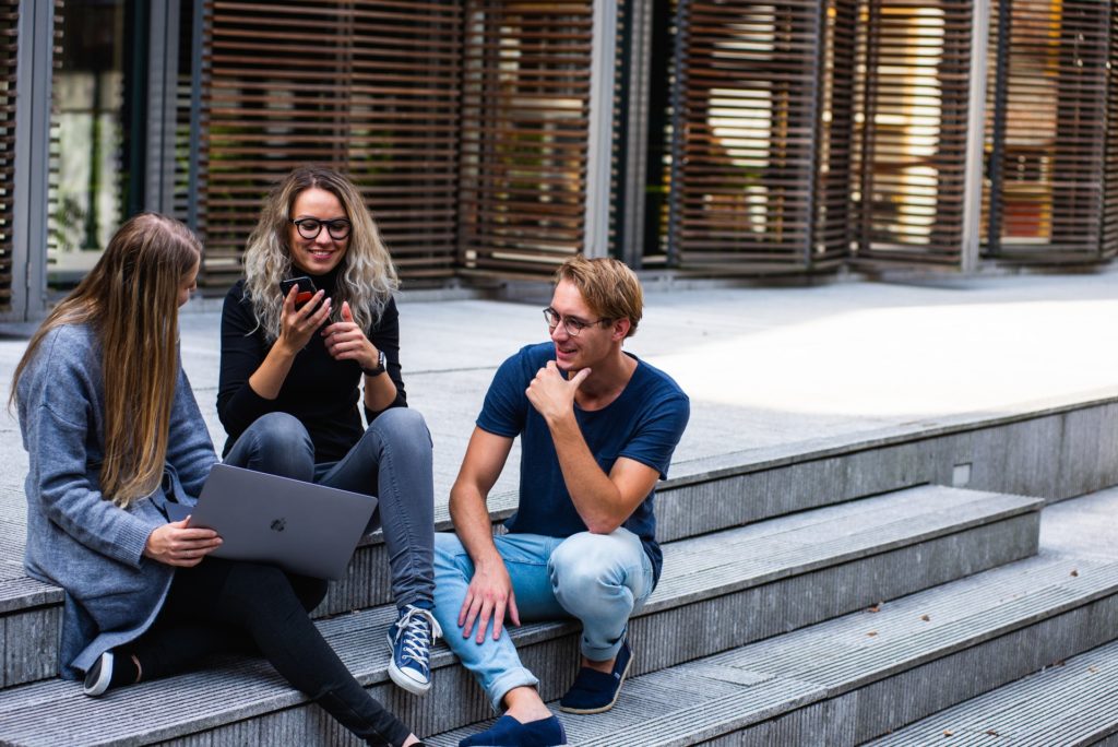 A group of young entrepreneurs talking on the steps