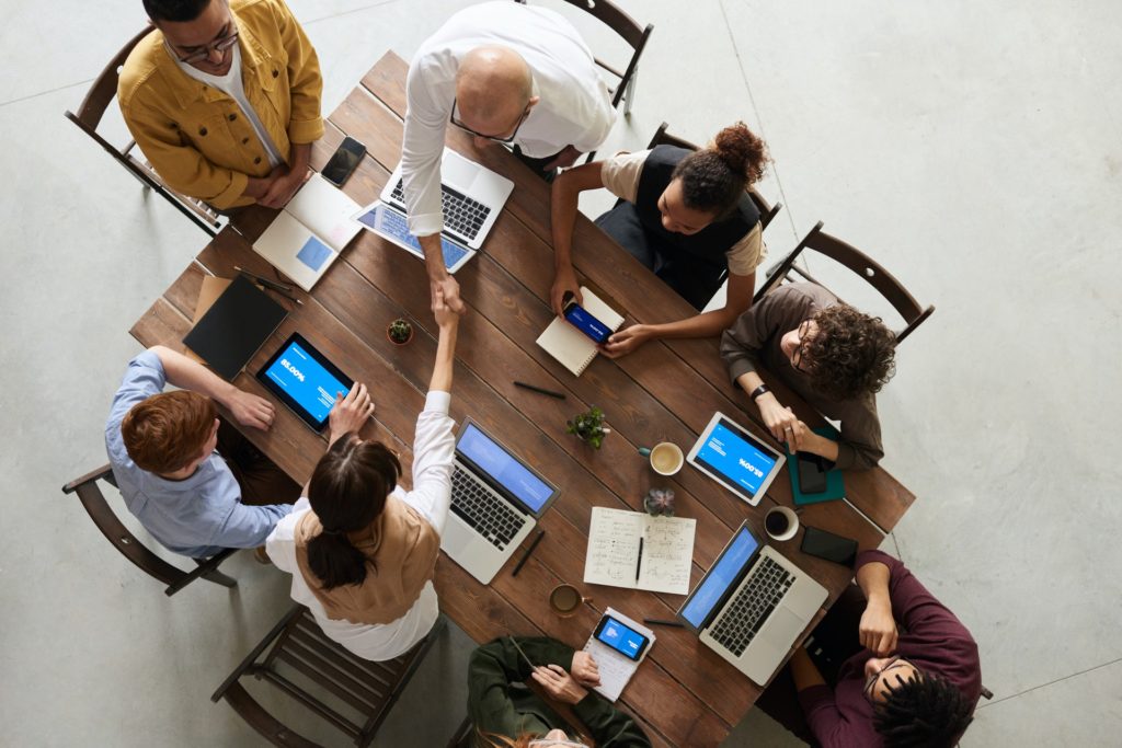 A team meeting together to discuss changes to processes