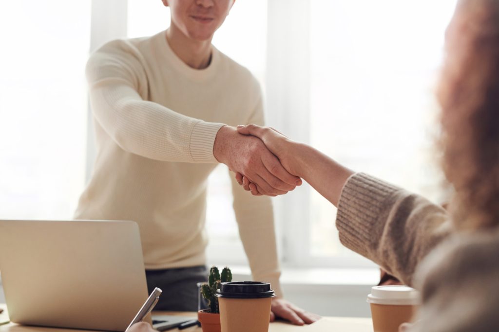 A man shaking hands with a new employee