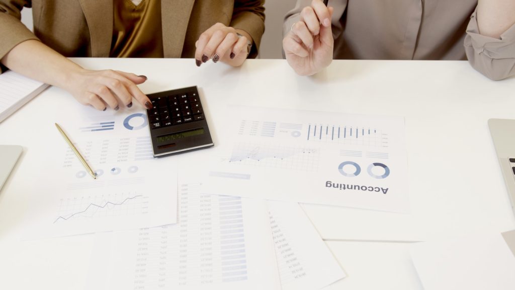 Two lady accountants working with a calculator