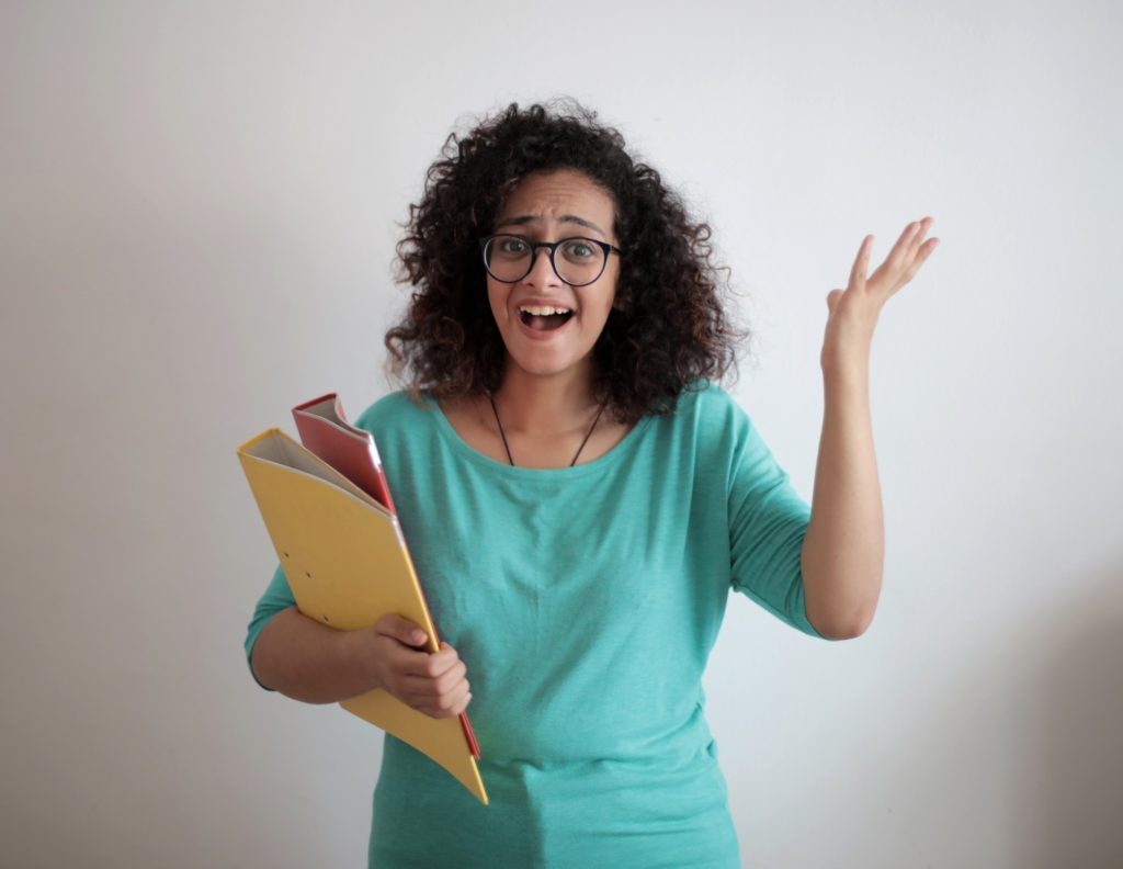 A lady business owner looking frustrated with files under her arm