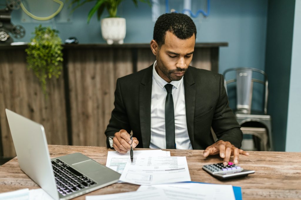 Accountant in a Black Suit Working with spreadsheets