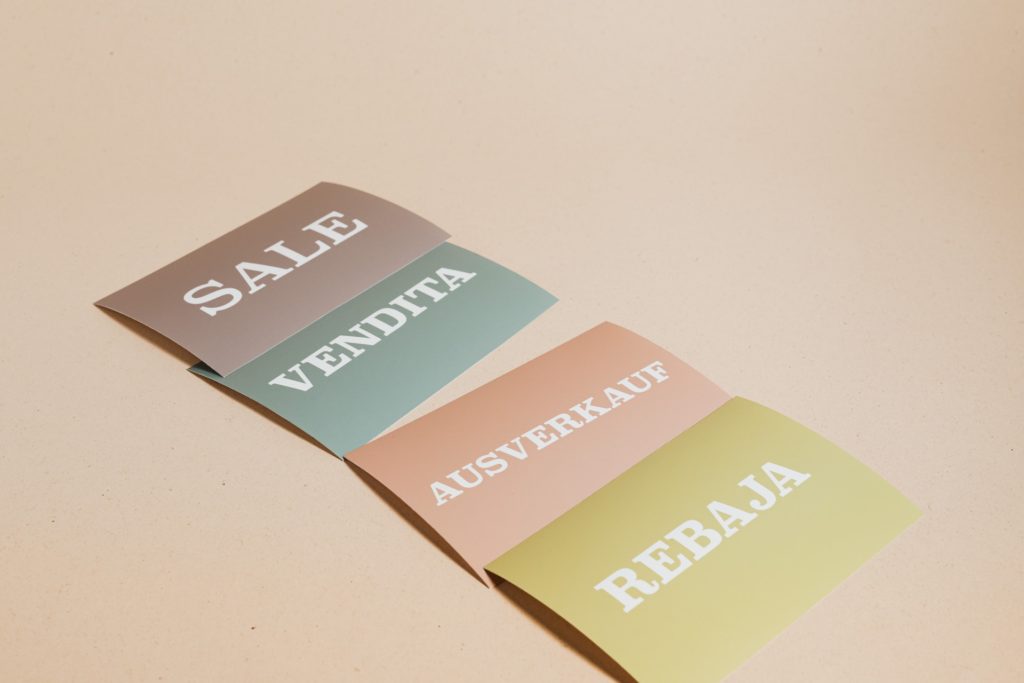 Four flashcards with the word "sale" in different languages