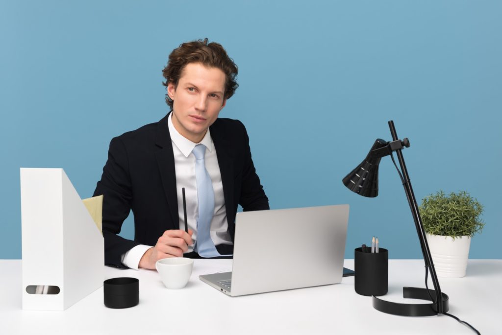 A businessman at his desk with a thoughtful look