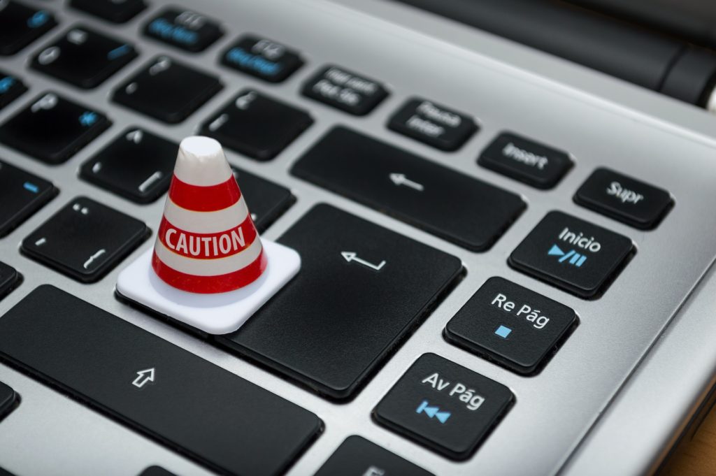 A mini cone on a keyboard with "caution" written on it