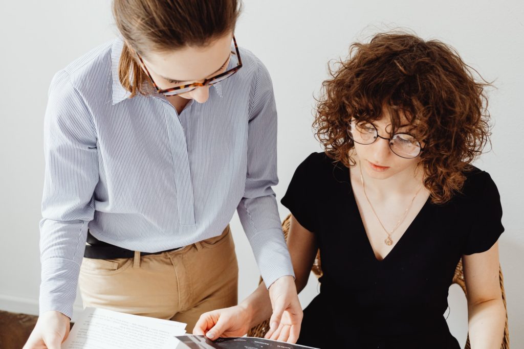 Two women doing their paperwork