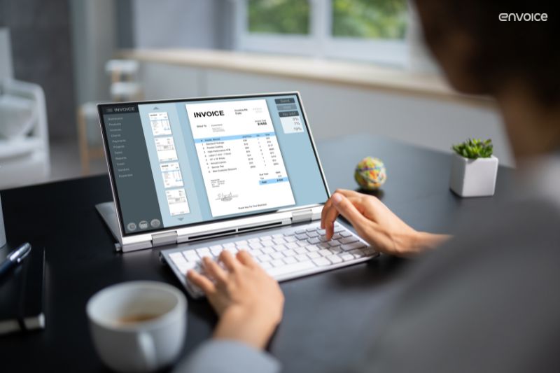 Person using AP automation software to manage digital invoices on a laptop.