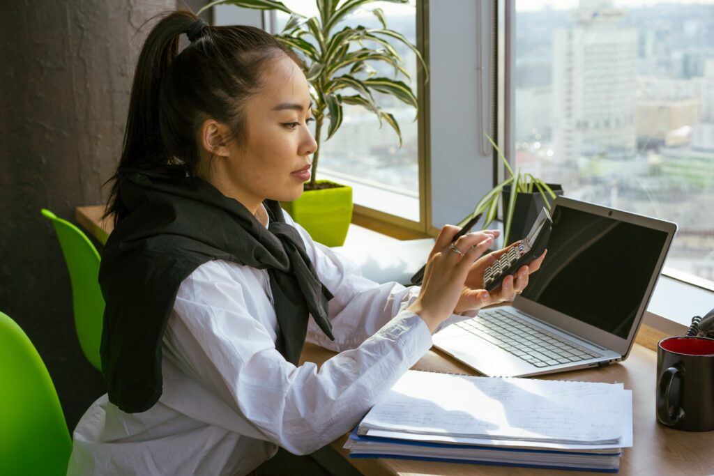 A lady accountant doing calculations at her desk