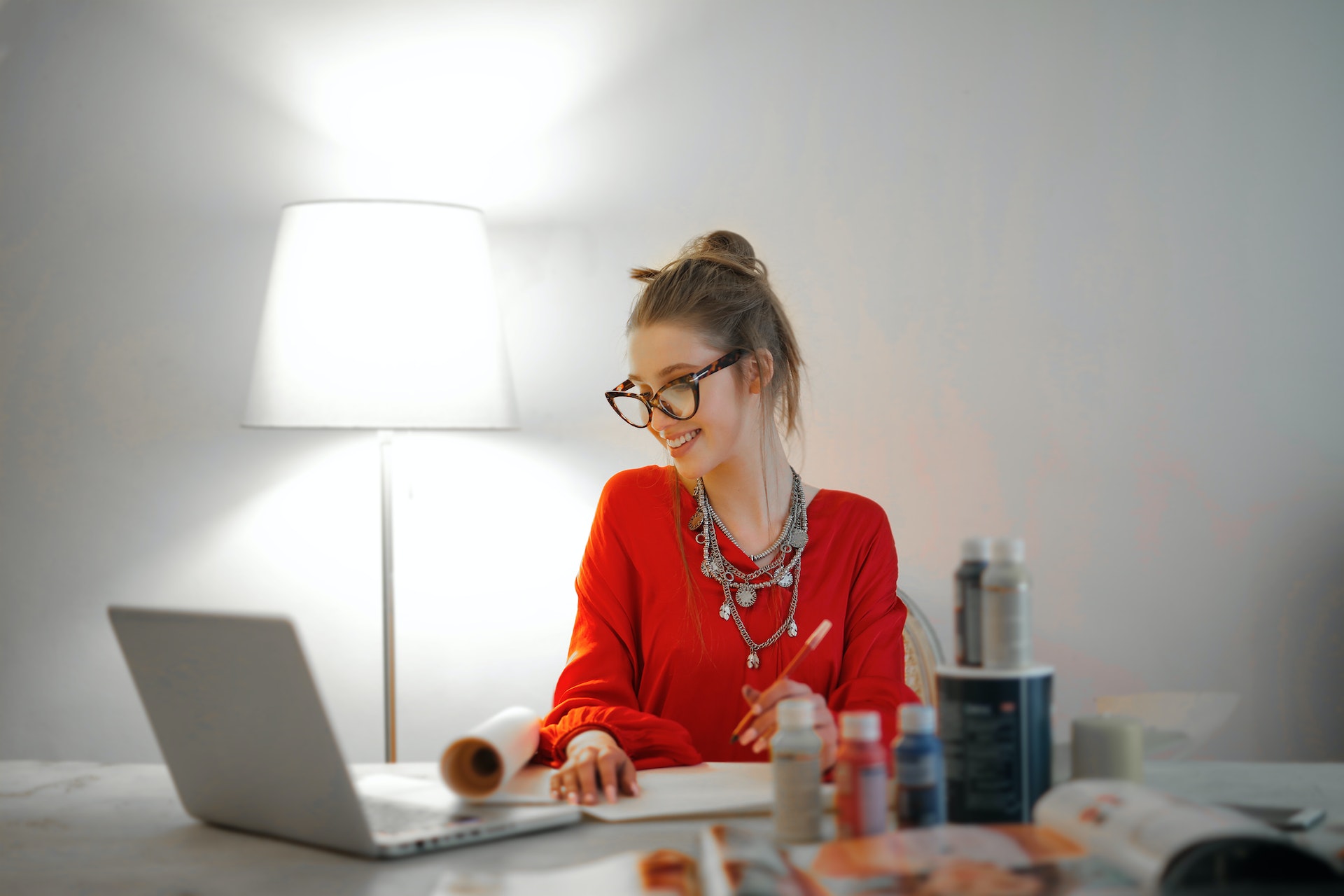 female accoutant-in-red-long-sleeve-shirt-looking-at-her-laptop