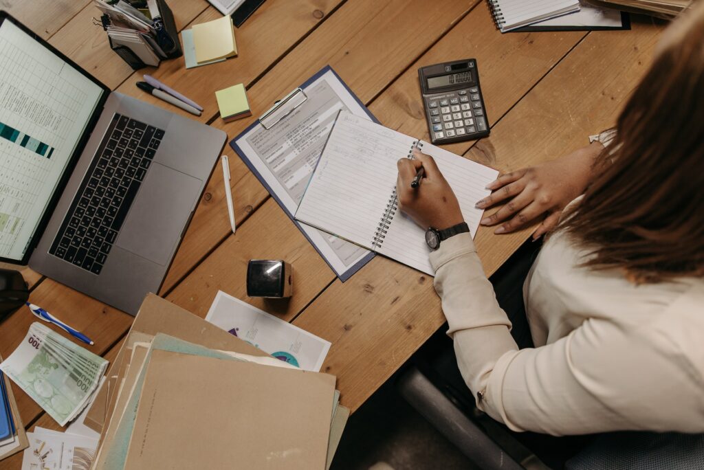 A female accountant writing in a notebook