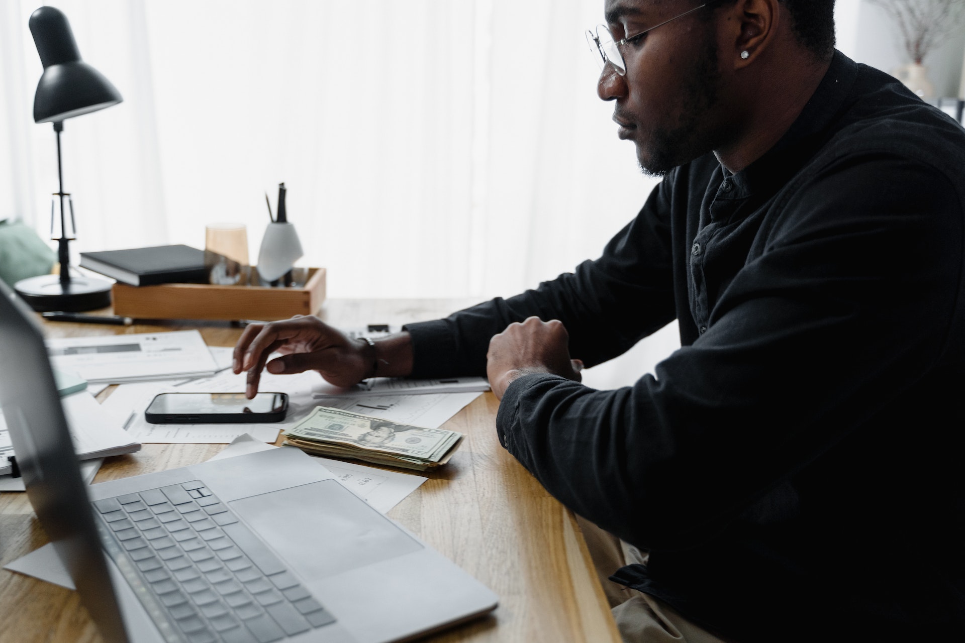 A male accountant working with paper invoices