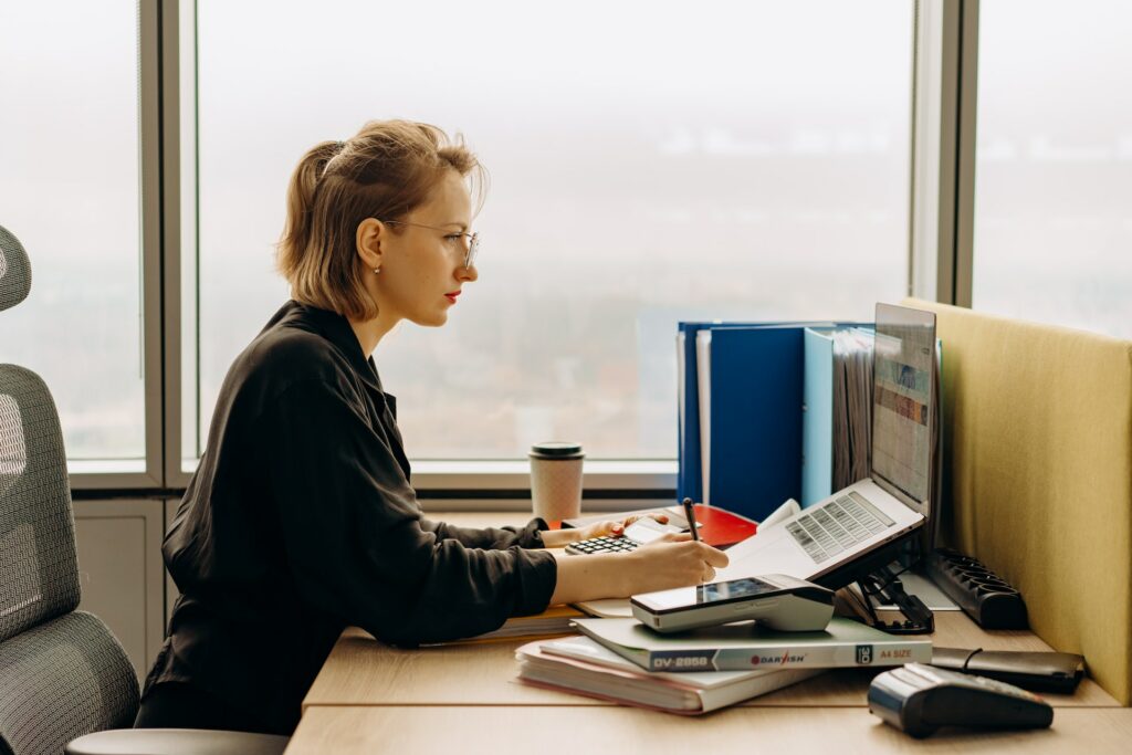 A lady accountant working with invoice scanning software on her laptop