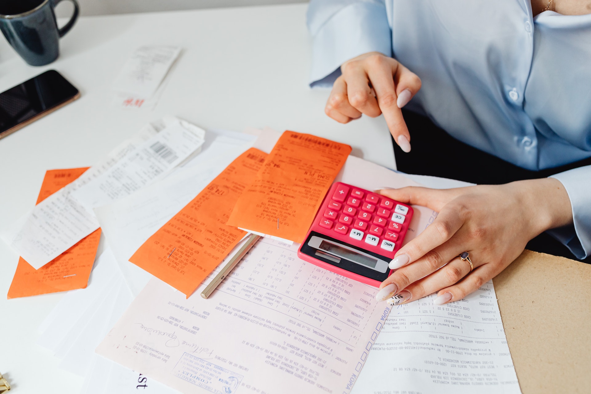 A female accountant adding receipts up on a calculator