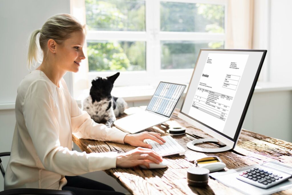 woman in front of computer preparing invoice