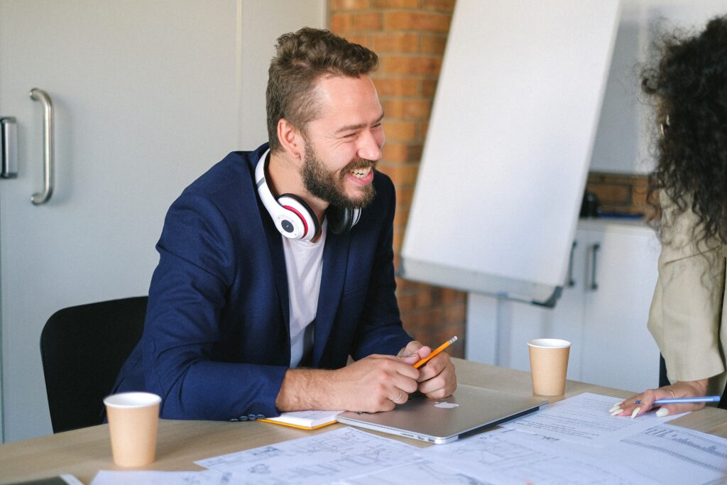 man-smiling-in-front-of-coworker