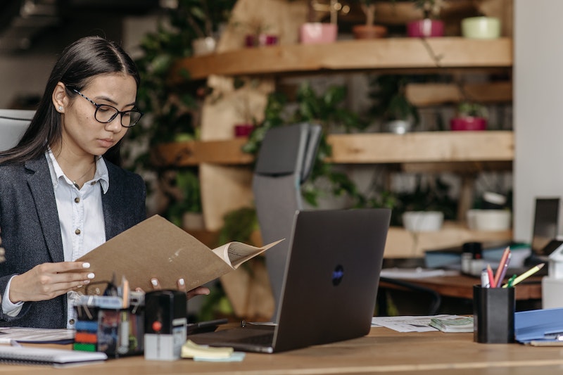 accountant woman holding a folder at work