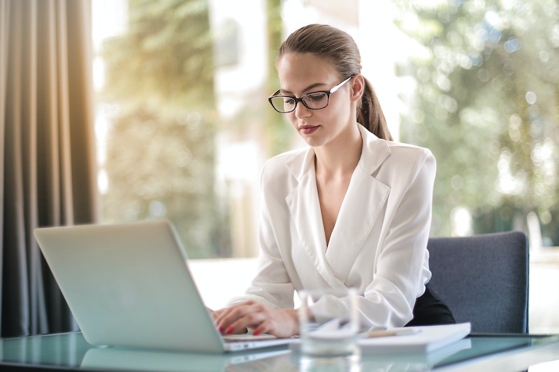 woman typing in her laptop