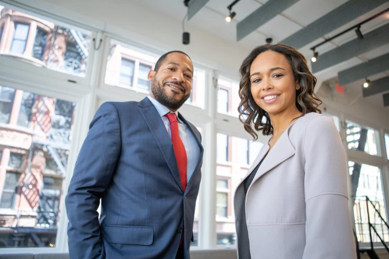 man and woman employees smiling