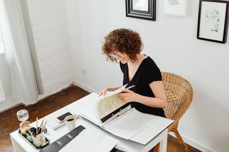 smiling woman doing paperwork