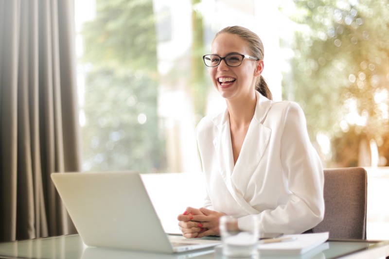 woman in white coat smiling