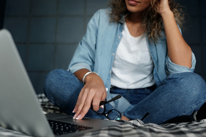 woman sitting in denim jeans