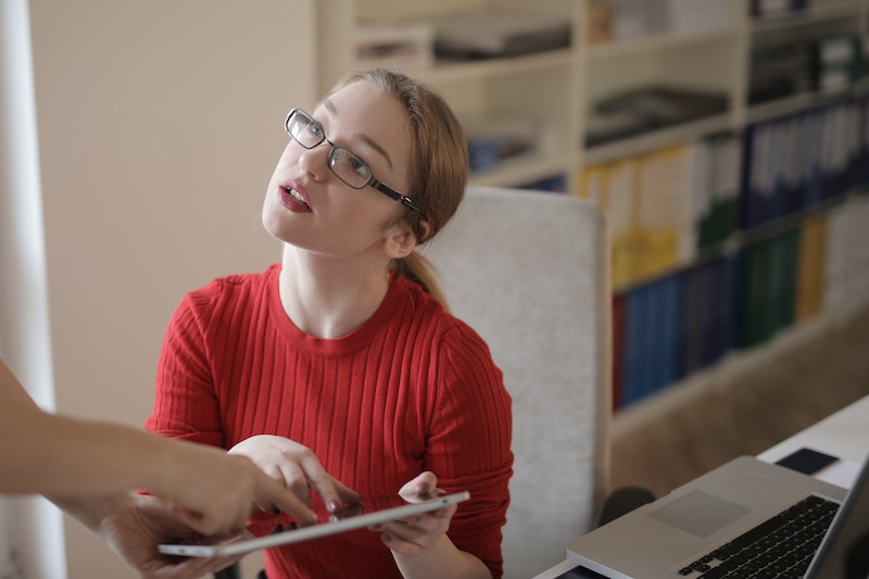 woman pointing at a tablet