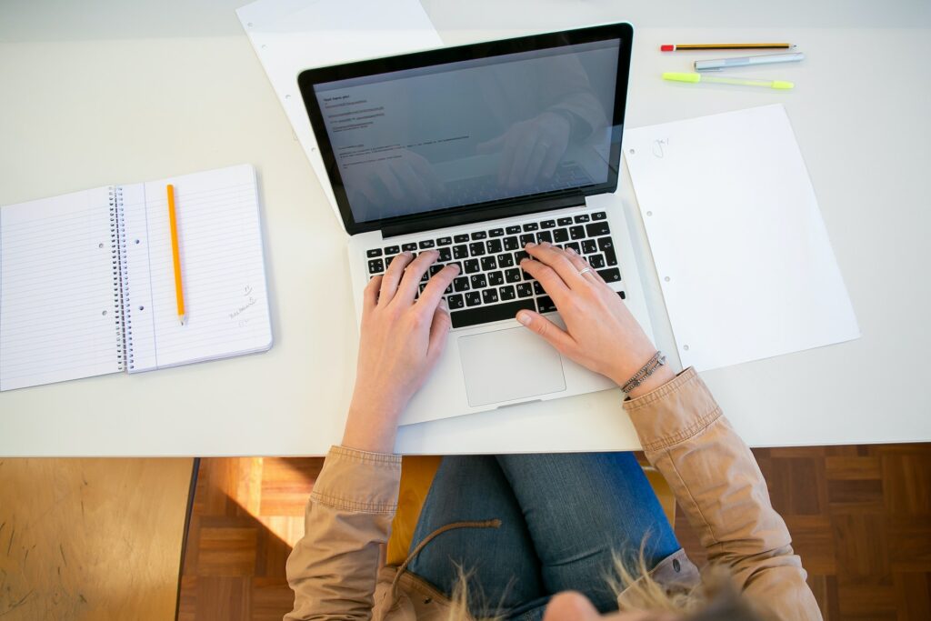 woman-working-on-laptop-with-documents