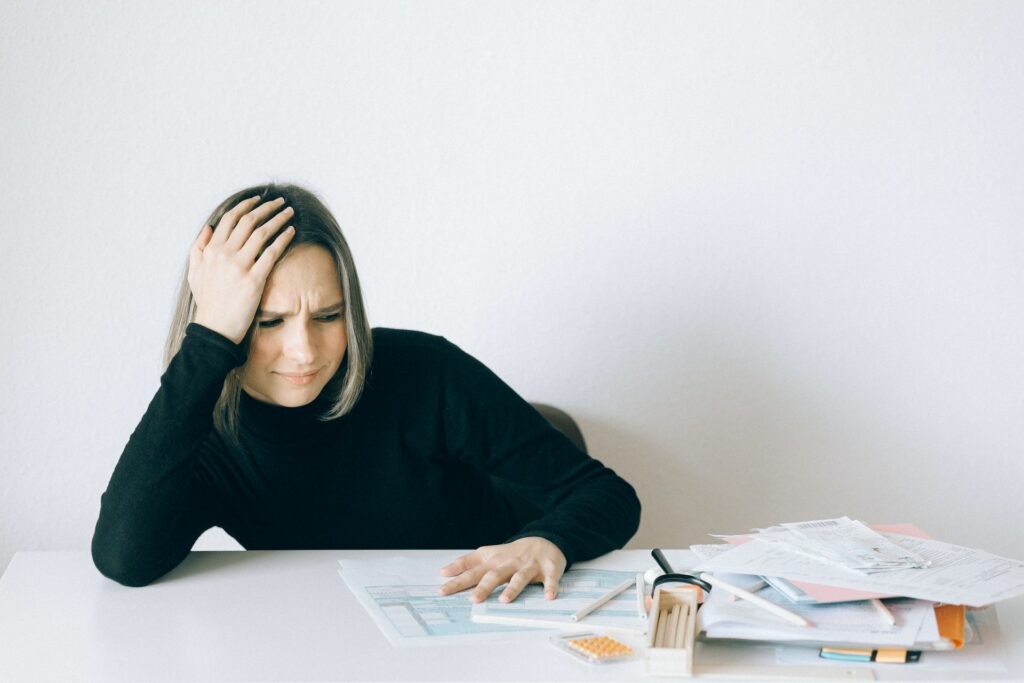 woman looking at her paper works