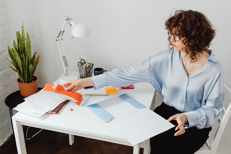 woman looking at receipts in office