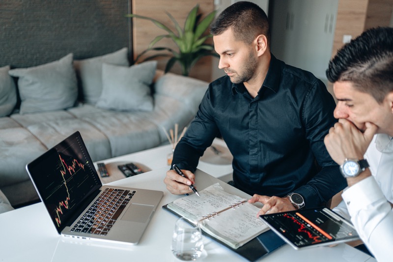 men looking at trends in laptop