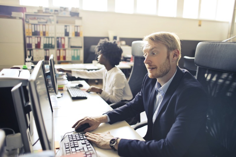 man surprised while looking at work computer