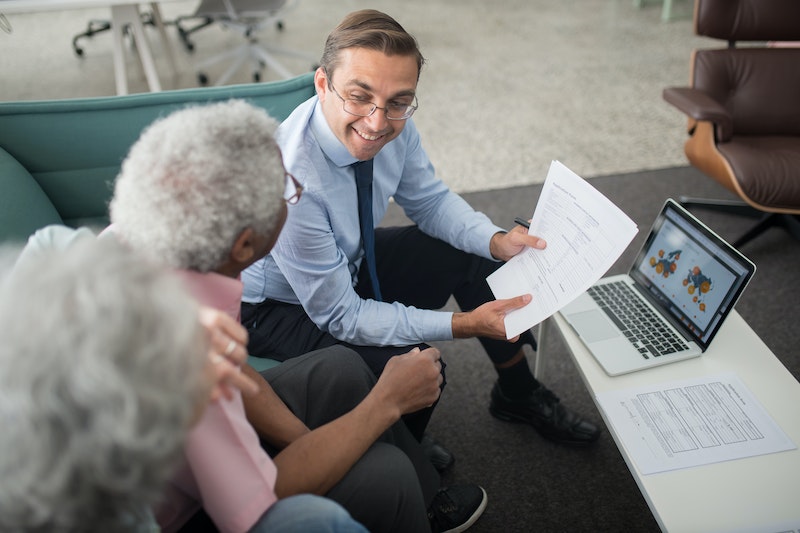 man Showing Documents to an Elderly Man 