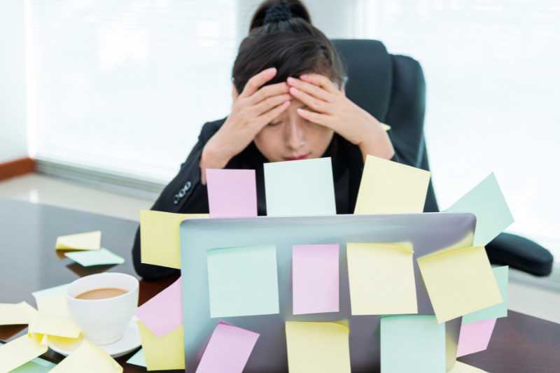 stressed office worker with post it notes