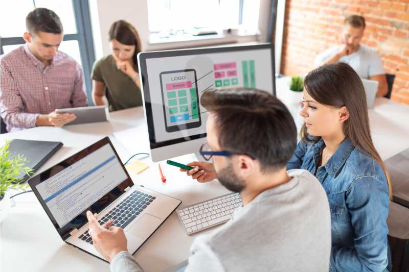 co-workers looking at laptop