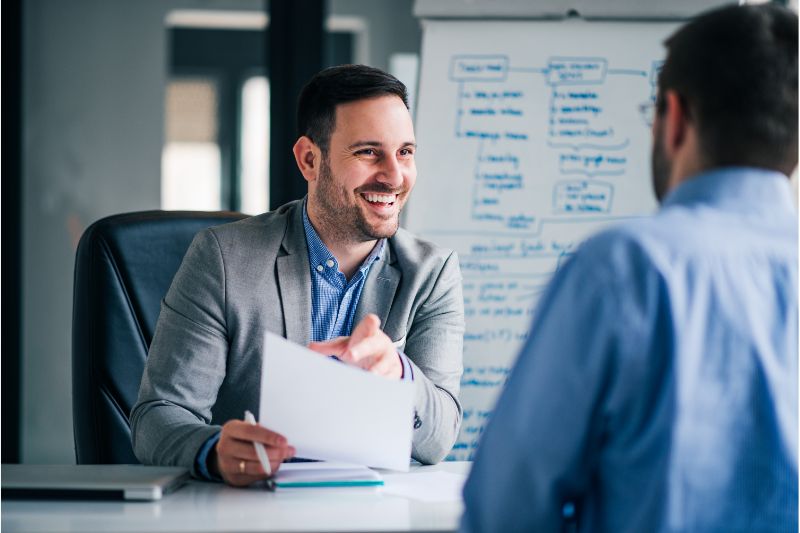 human resource personnel happy interviewing an applicant