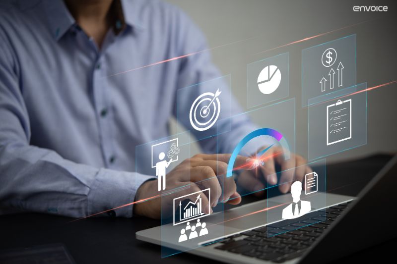 Professional using software dashboard to visualise benefits of automated invoice processing in real time.