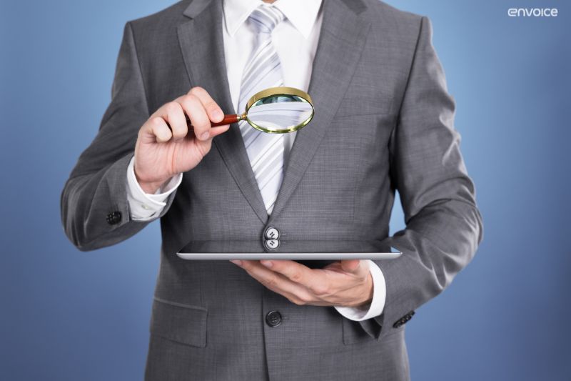 Businessman analysing tablet, symbolising transparency and accuracy benefits of automated invoice processing.